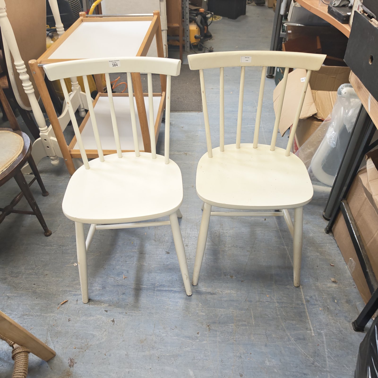 Pair of white stick back dining chairs for kitchen or dining room.