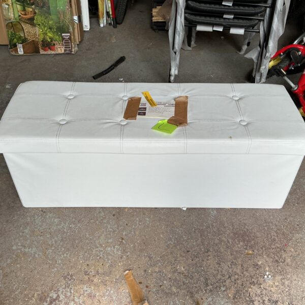 White upholstered storage ottoman, foldable design for easy storage.