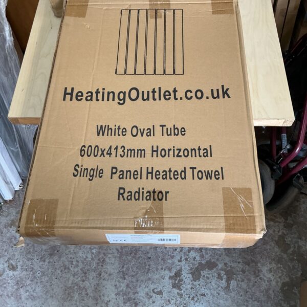 White 600x413mm horizontal single panel heated towel radiator in packaging.