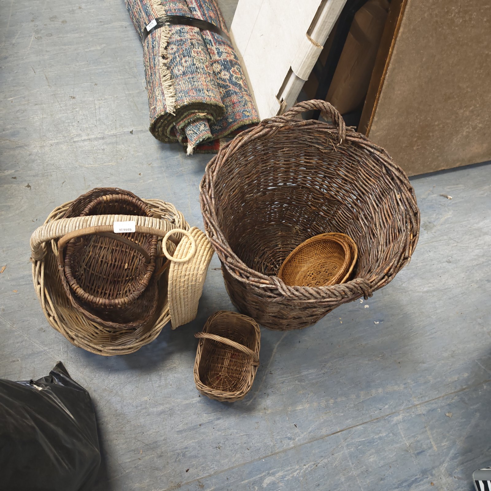 Bundle of vintage wicker baskets for storage and display.