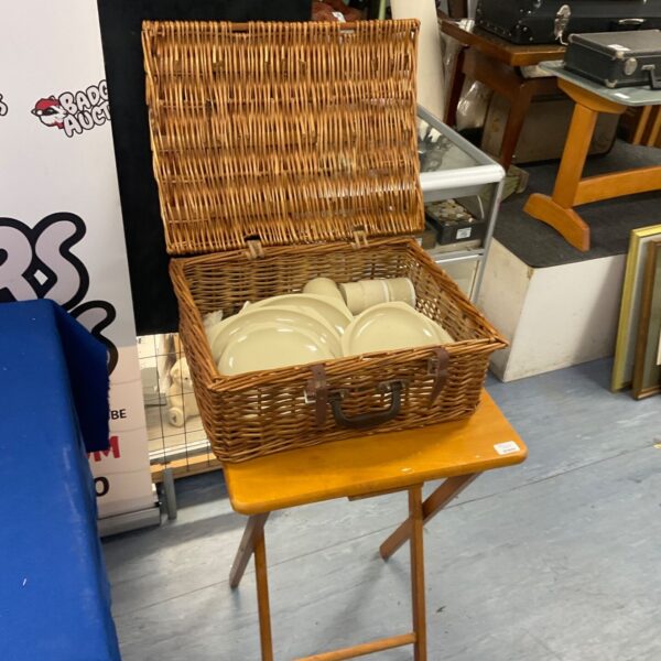 Vintage wicker picnic basket with a small folding table.