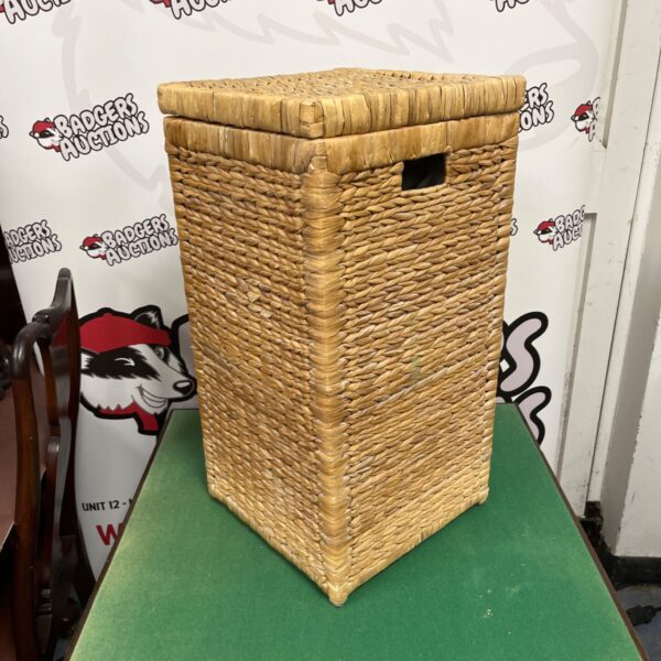 Tall wicker wash bin for laundry storage, rustic farmhouse style.