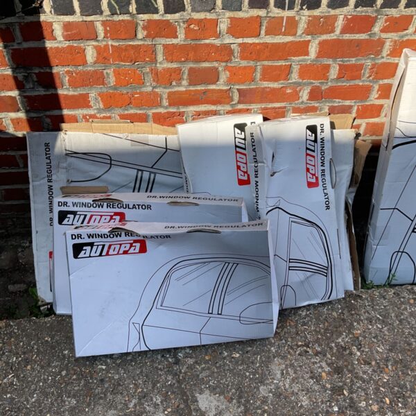 Stacked Autopa window regulator boxes against a brick wall.