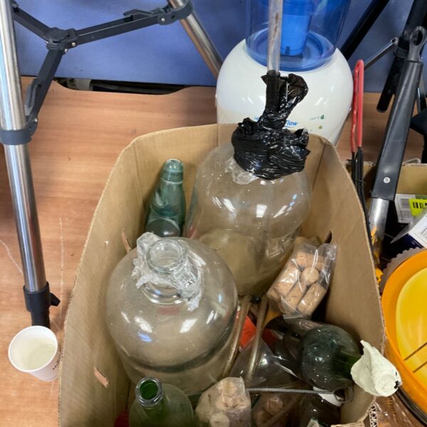 Box of used wine making equipment and supplies.