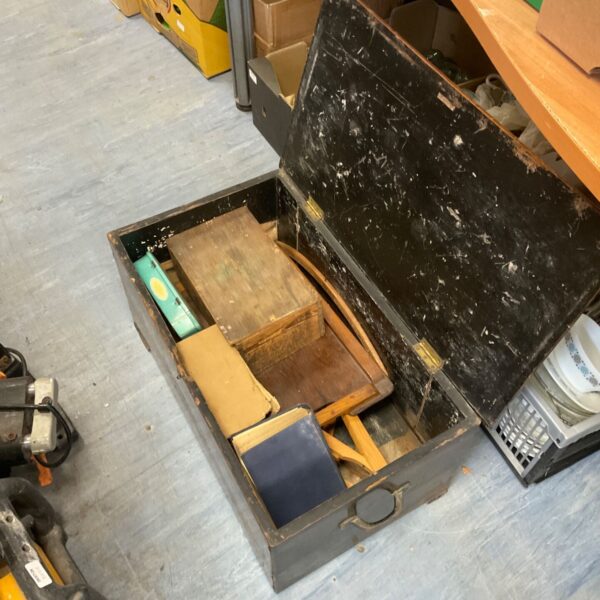 Vintage wooden chest filled with various contents, a collectible storage item.
