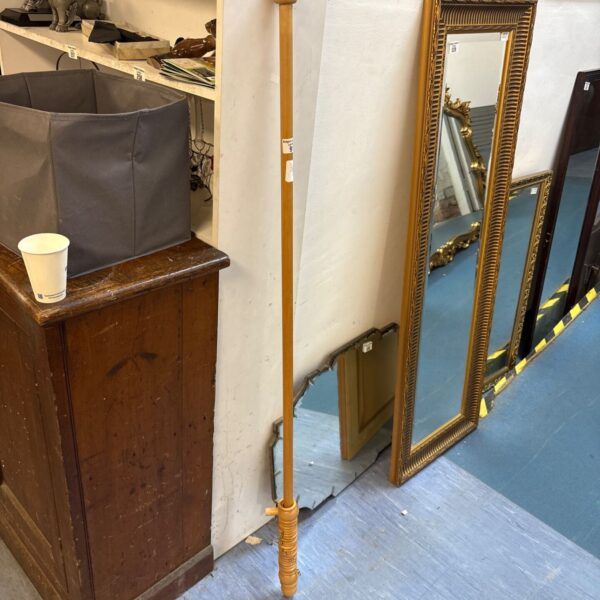 Vintage wooden curtain pole with decorative finial, ideal for home decor.