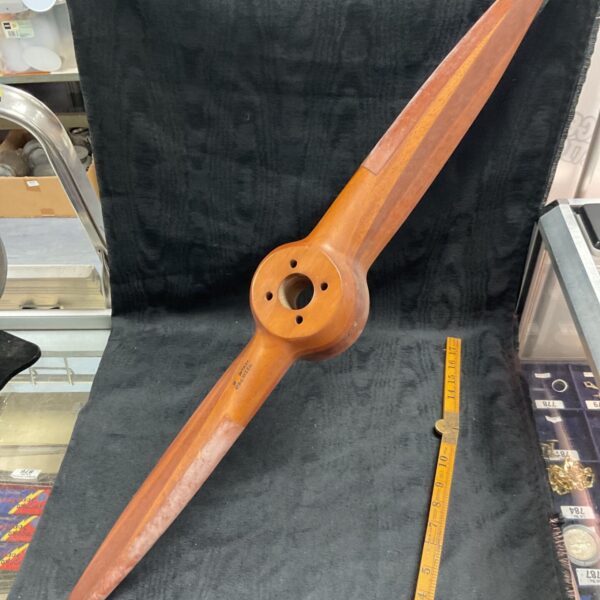 Vintage wooden drone propeller with metal hub.