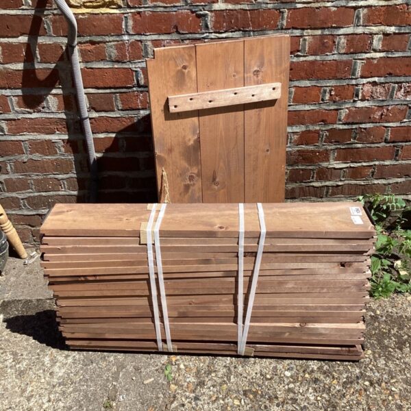 Wooden garden storage box bound with straps, ready for use.
