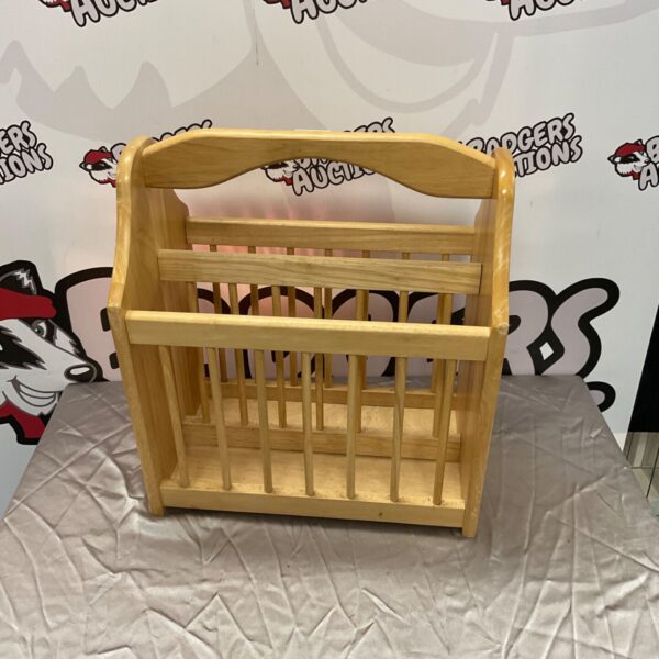Vintage wooden magazine rack for storing books and magazines.