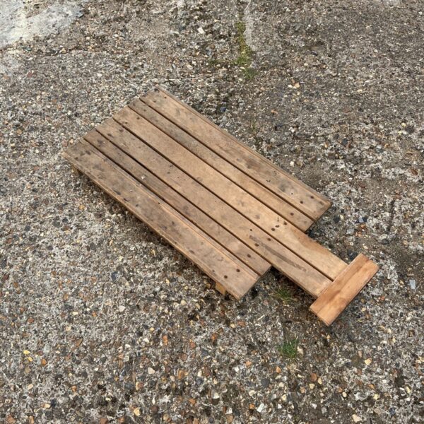 Vintage wooden mechanics crawler for workshop use.