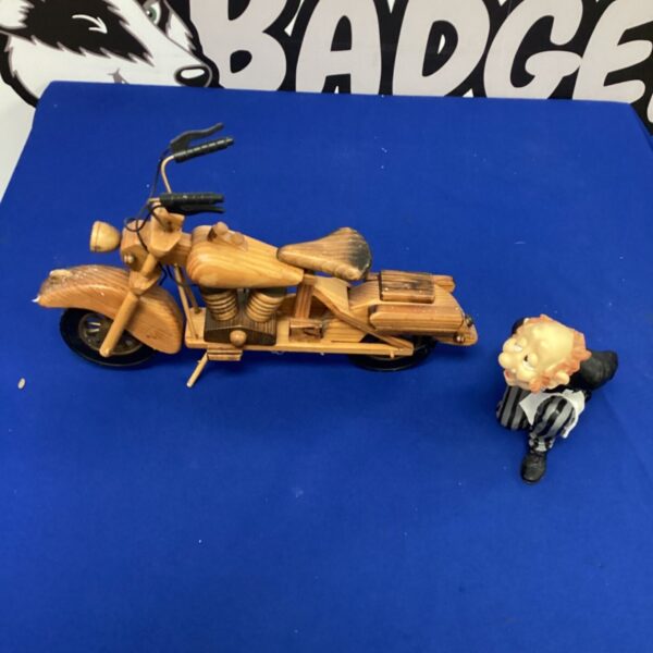 Hand-carved wooden motorcycle sculpture with bottle holder.