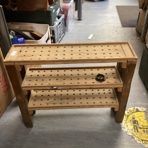 Rustic wooden shoe rack for hallway storage.