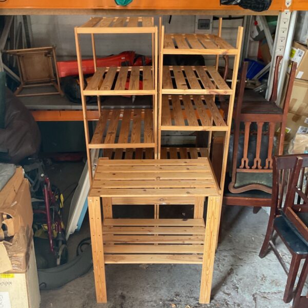 Three wooden storage racks for garage or workshop organization.