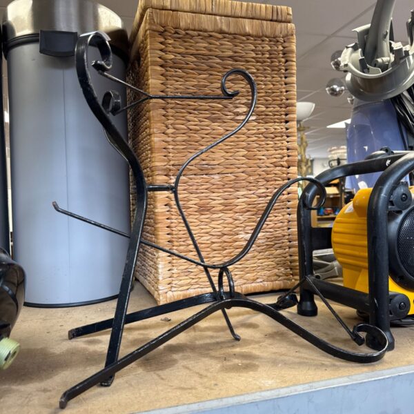 Pair of antique wrought iron plant stands with a woven basket.