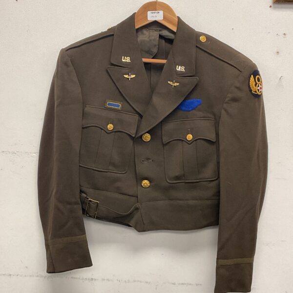 Original WWII USAAF Ike jacket with badges displayed.