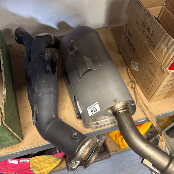 Yamaha exhaust silencer, motorcycle part, showing wear and tear.