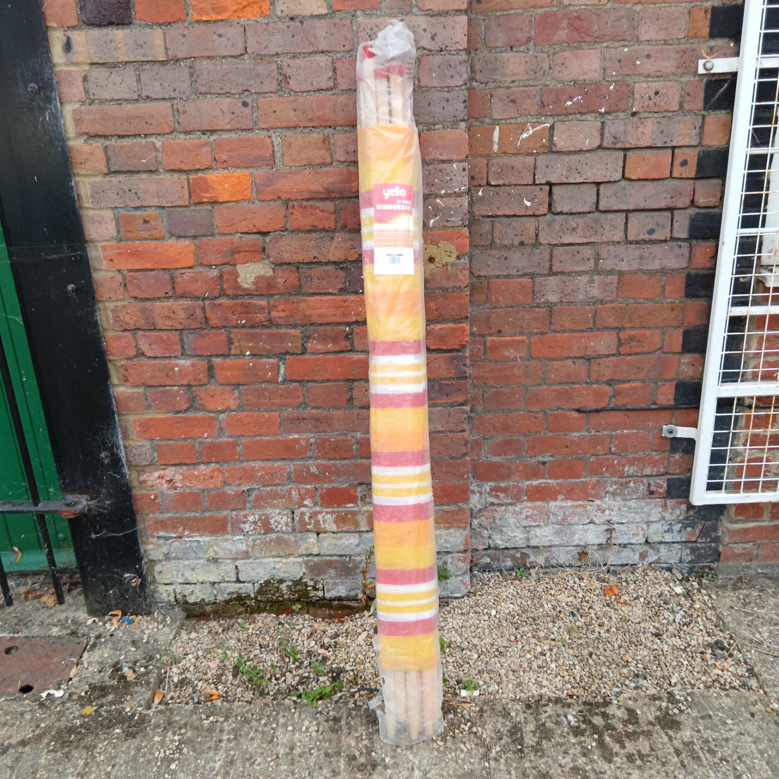 Colourful striped Yello windbreak for beach and garden use.