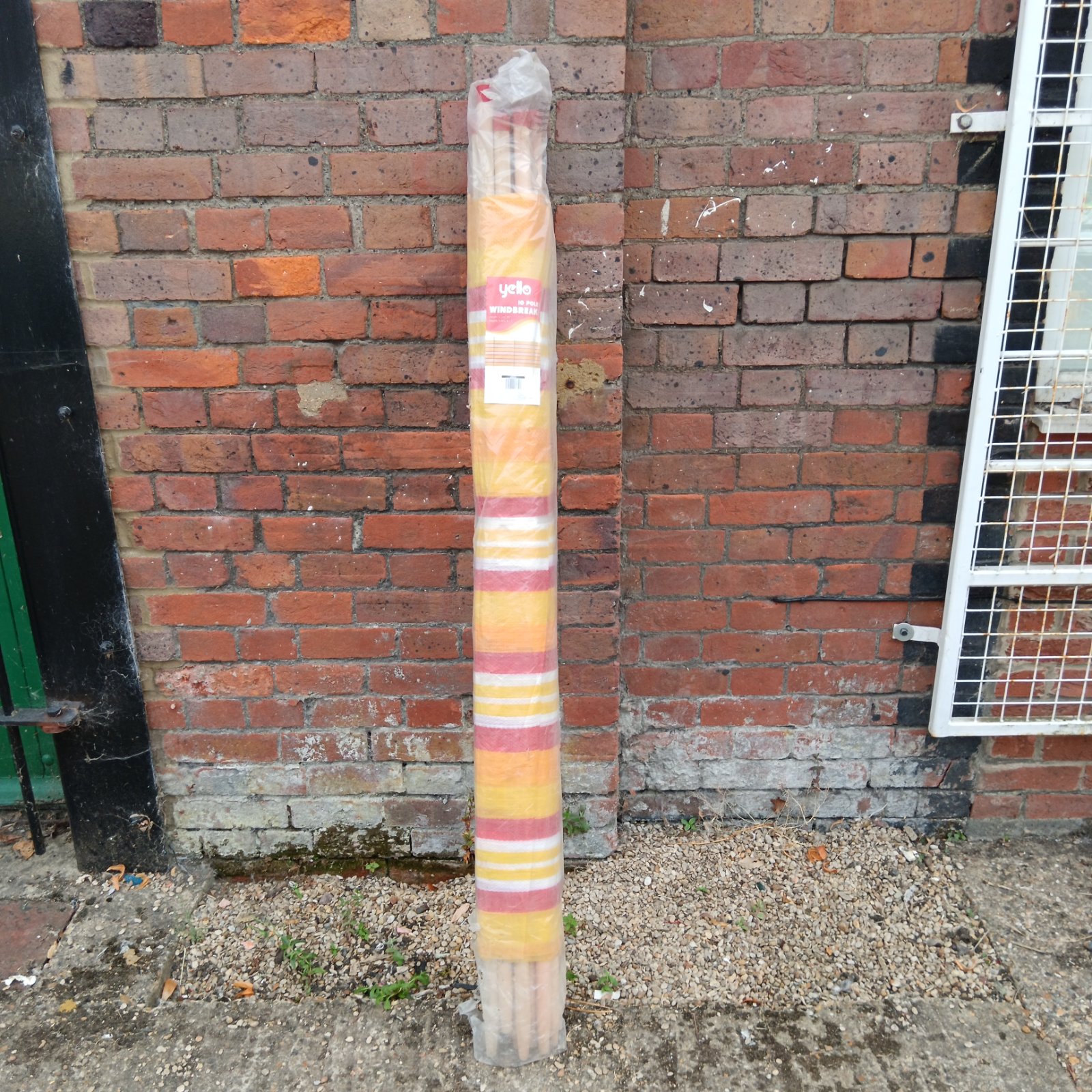 Colourful striped Yello windbreak for beach and garden use.