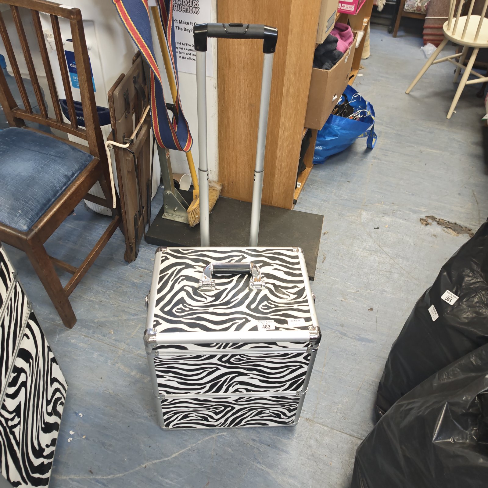 Zebra print makeup artist travel case with wheels and handle.