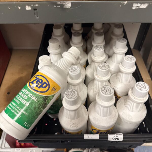 Multiple bottles of Zep artificial grass cleaner solution for garden maintenance.