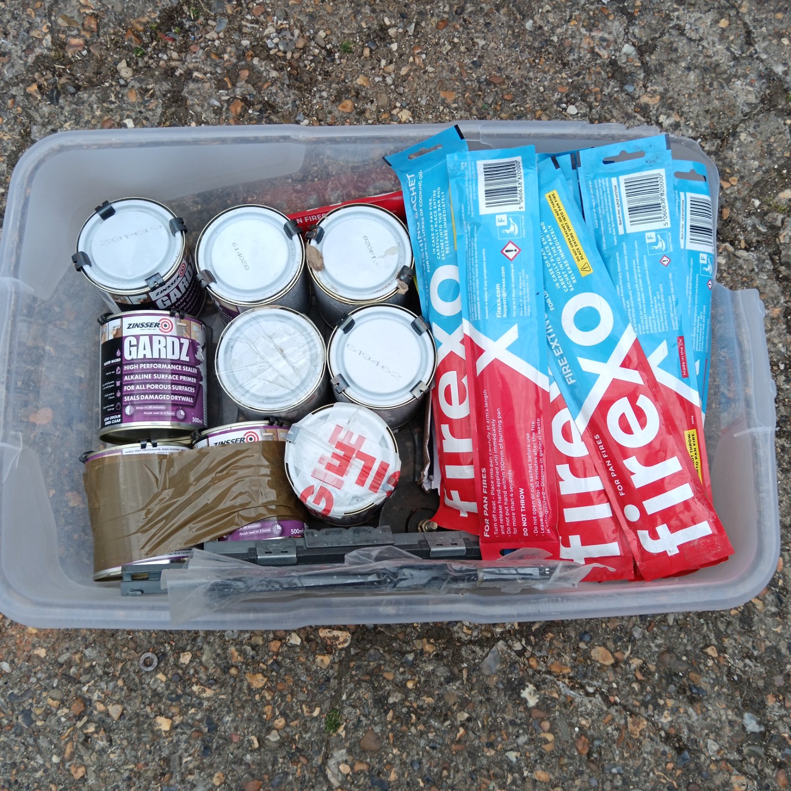 Zinsser sealer cans and Firexo pan fire extinguishers in a box.