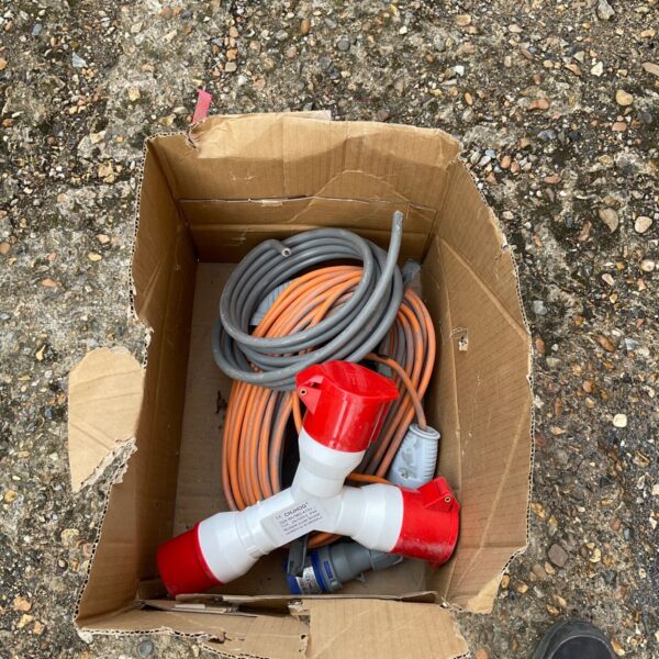 110v extension reel with orange cable and connectors.