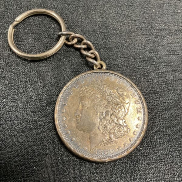 Antique 1880 silver dollar keyring with Liberty portrait.