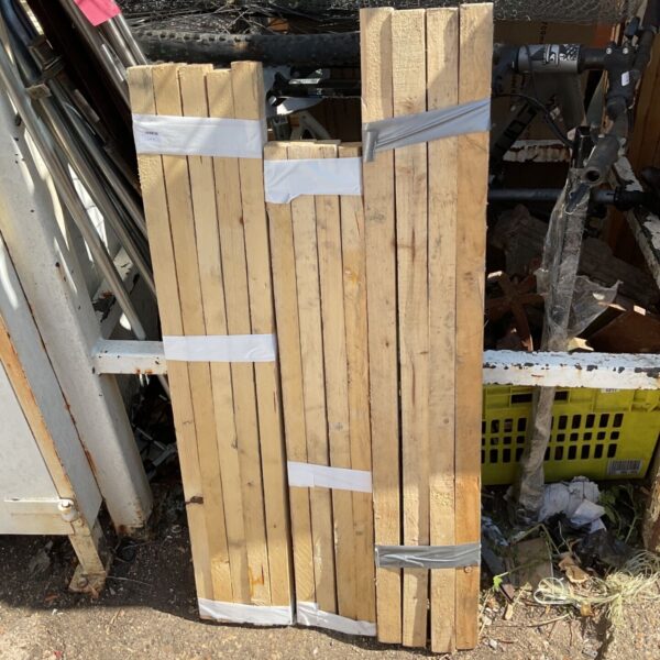 Stack of 2x4 lumber bundles for construction projects.