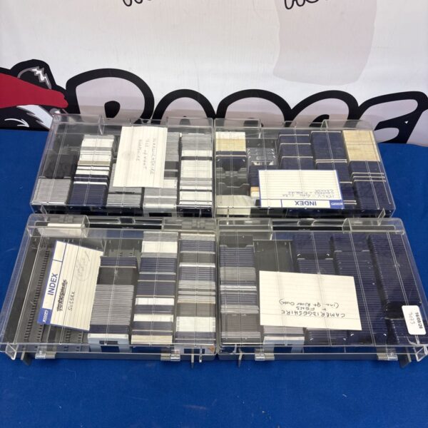 Collection of vintage 35mm projector slides in protective sleeves.