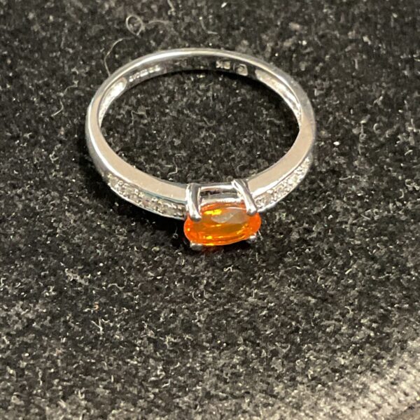 9ct white gold ring with orange sapphire gemstone and white accents.