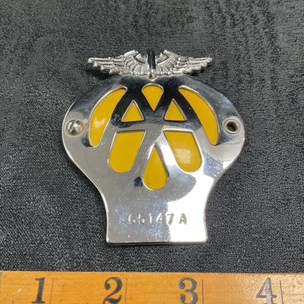 Vintage AA motorcycle badge with yellow enamel and silver wings.