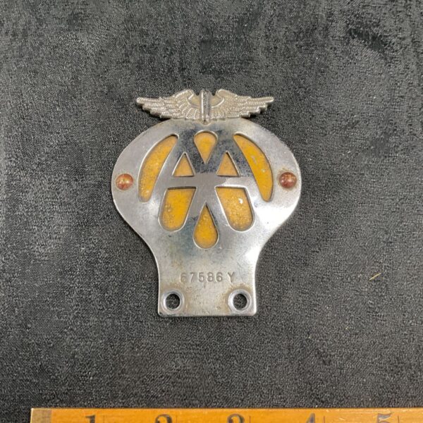 Vintage AA motorcycle badge with white enamel and brass surround.
