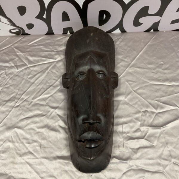 Antique African tribal mask with detailed wood carving.