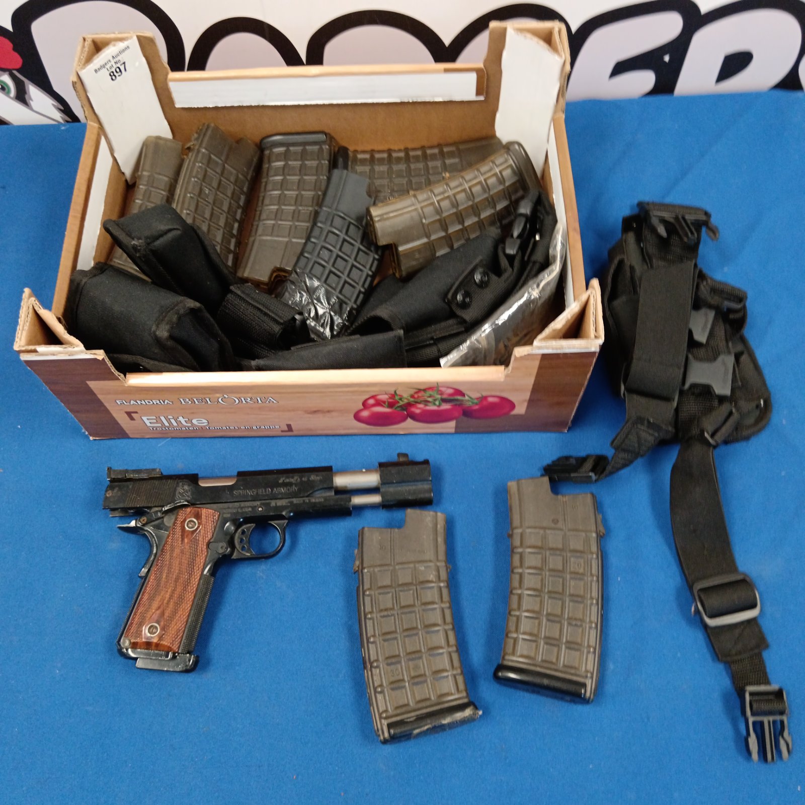 Airsoft pistol lot with magazines and holster for tactical games.