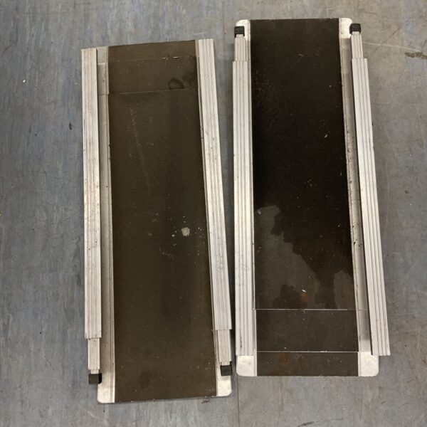 Pair of aluminium wheelchair ramps with black grip surface.