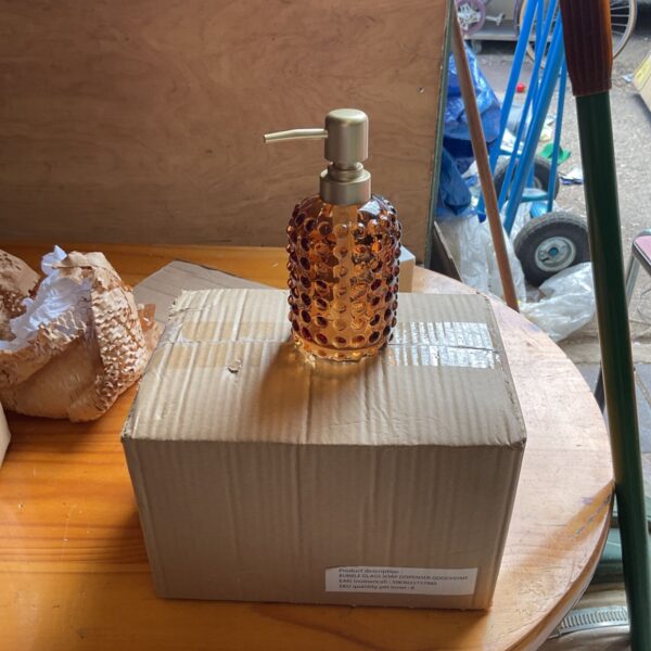 Lot of six amber glass soap dispensers with ribbed texture.