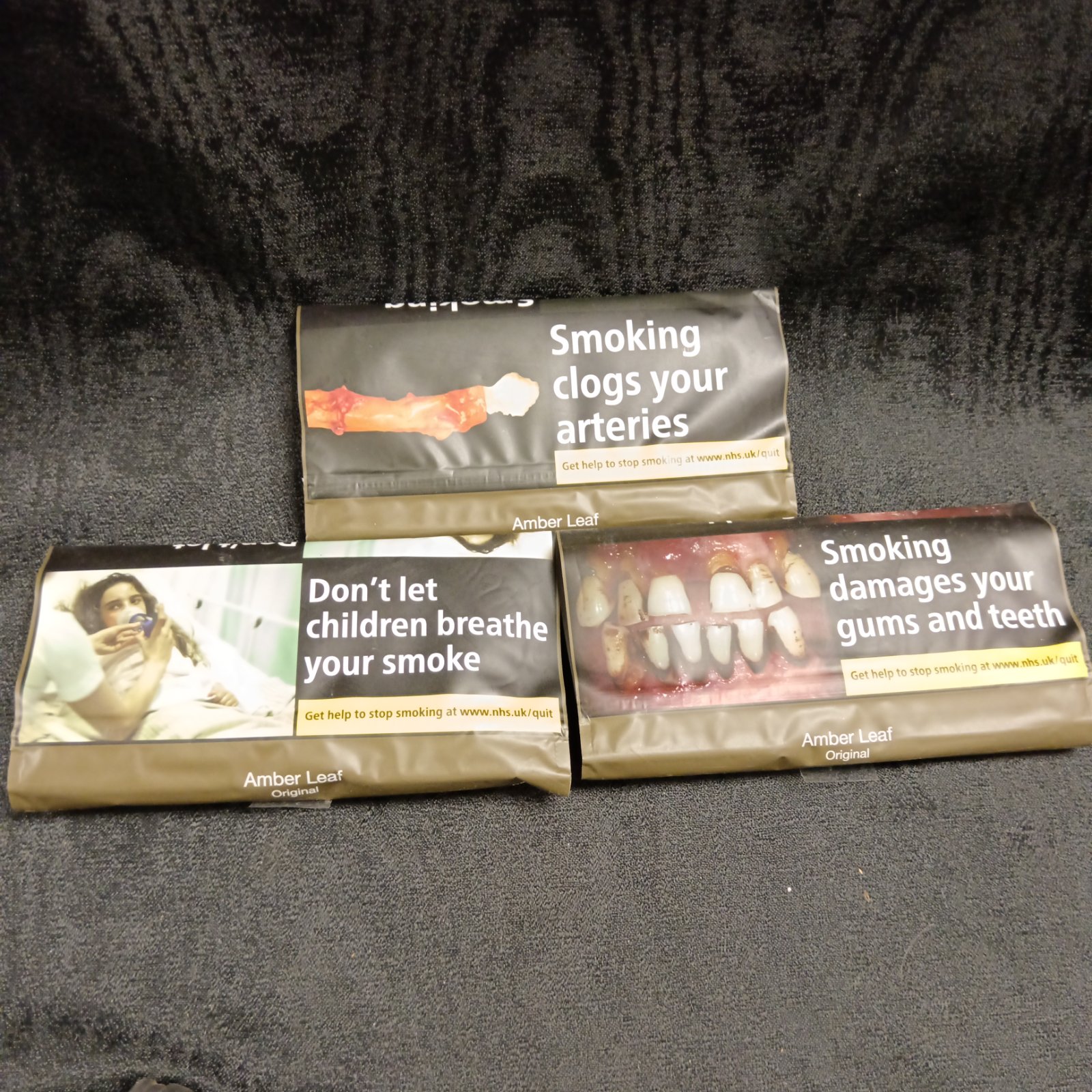 Sealed packs of vintage Amber Leaf rolling tobacco for collectors.