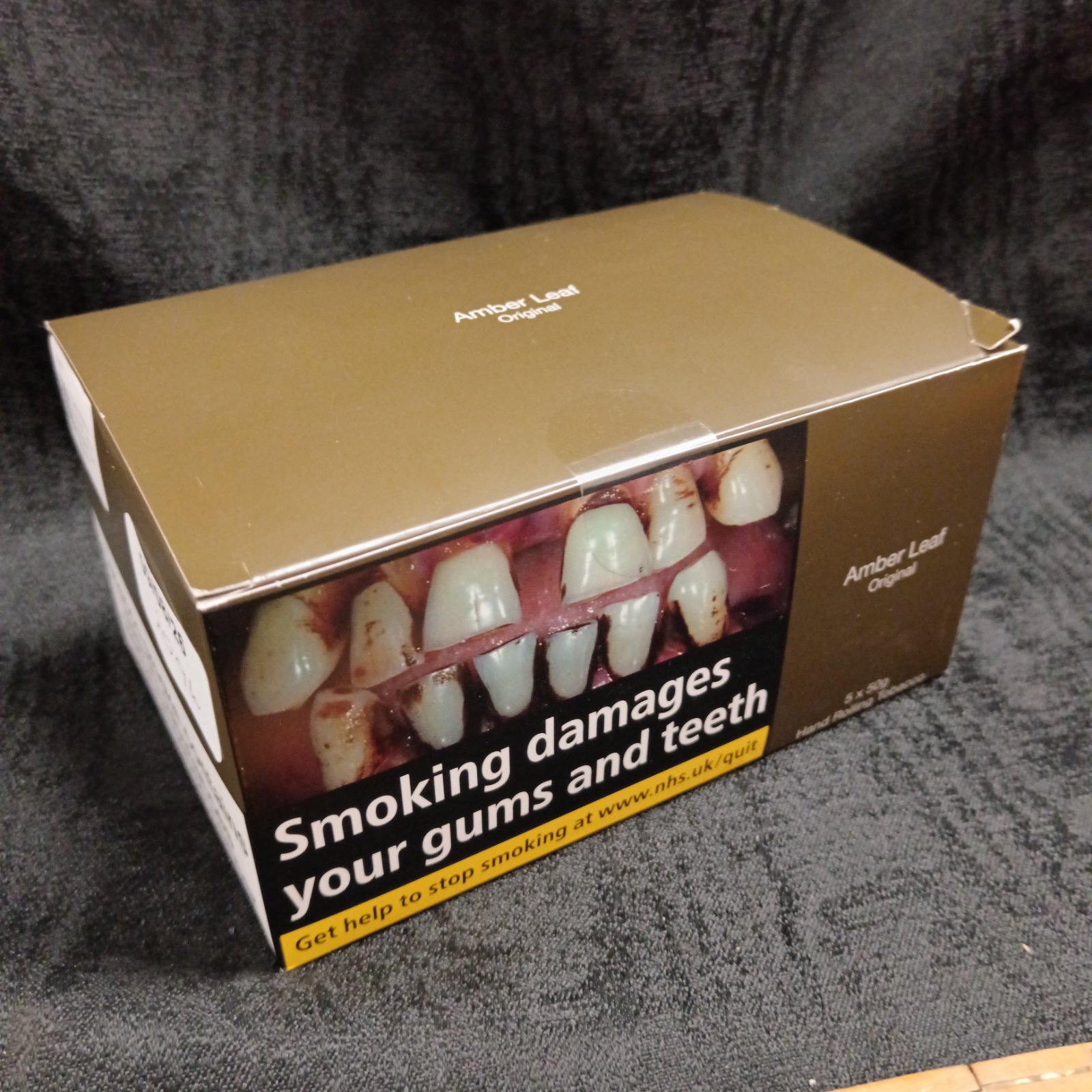 Five unopened packs of Amber Leaf Original hand rolling tobacco.