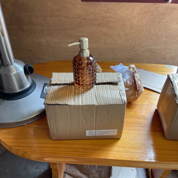 Lot of five vintage amber plastic soap dispensers.
