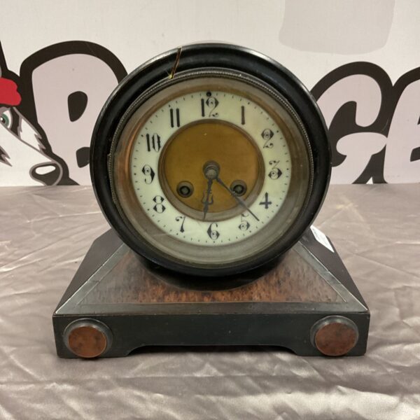 Antique Ad Mougin A1 barrel mantle clock with a white face.