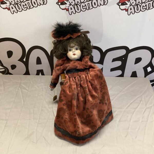 Antique bisque china doll by Wupper in rocking chair.