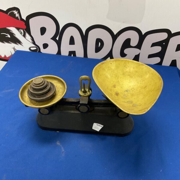 Antique brass balance scales with weights for accurate measurement.
