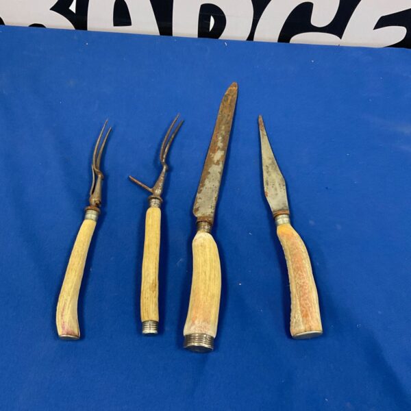 Antique carving set with bone handles and silver collar.