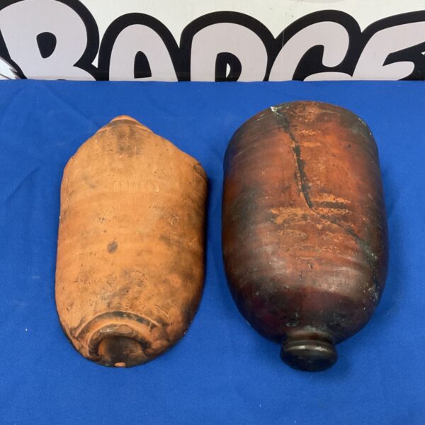 Antique clay C&M Hemstock container halves on blue backdrop.