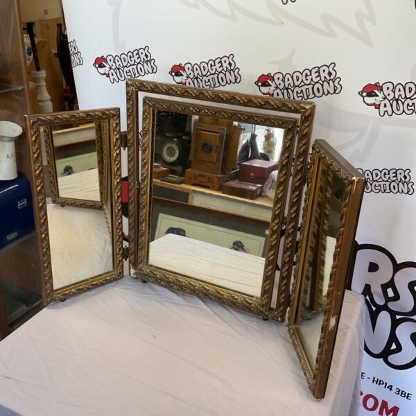 Antique three-piece dresser mirror with ornate gold edging.