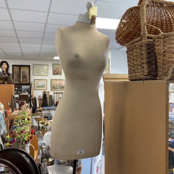 Antique dressmaker’s mannequin with wooden stand, vintage sewing form.