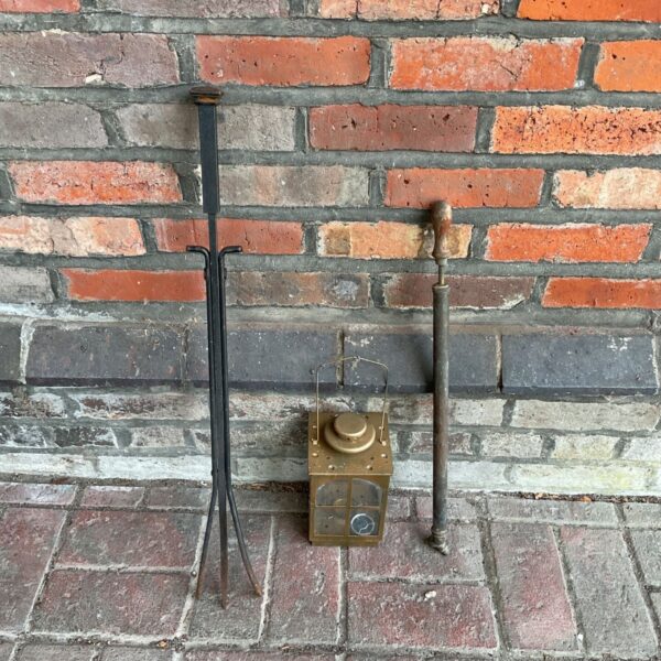 Antique fireplace tools with Victorian candle lantern and sprayer.