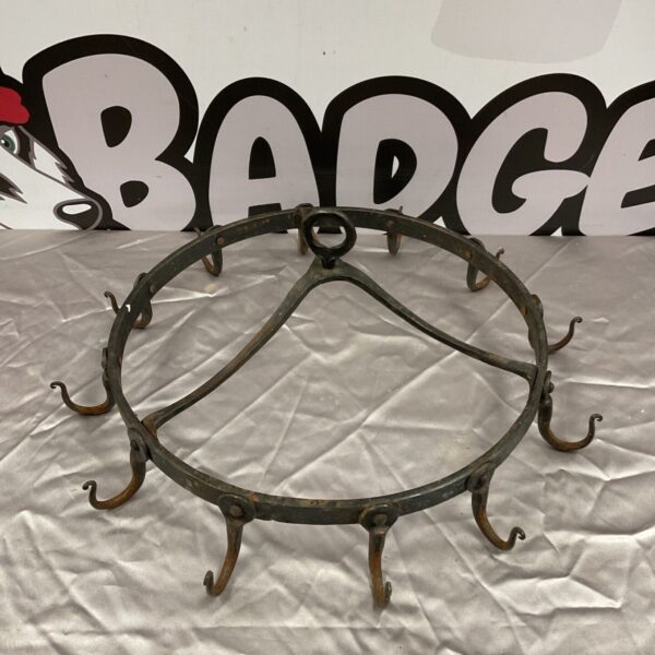 Antique wrought iron game crown hook rack with multiple hooks.
