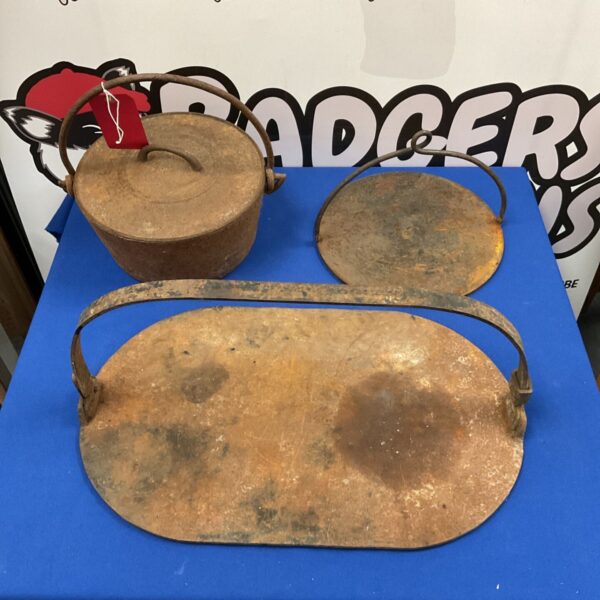 Antique cast iron gypsy griddles and pot for vintage cooking.