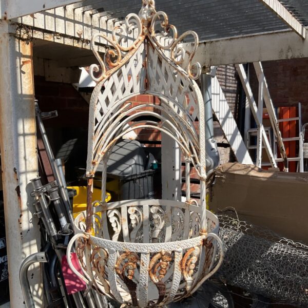 Ornate antique hanging basket metal frame for garden plants.